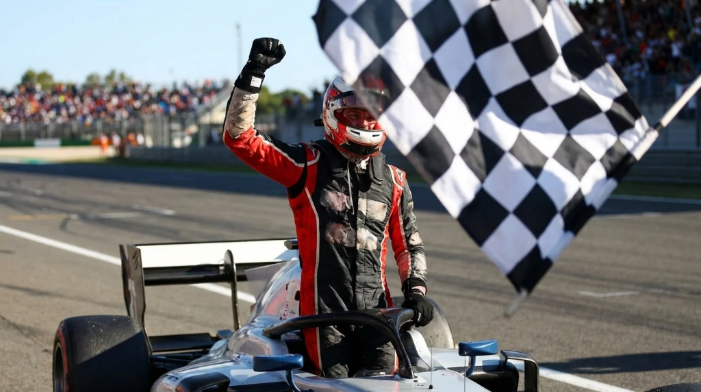Current image: Pilote de Formule 1 célébrant sa victoire avec le drapeau à damiers